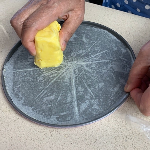 cut baking paper in a circle and butter it